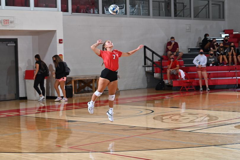 Brooke Hall jumping up to spike the volleyball.